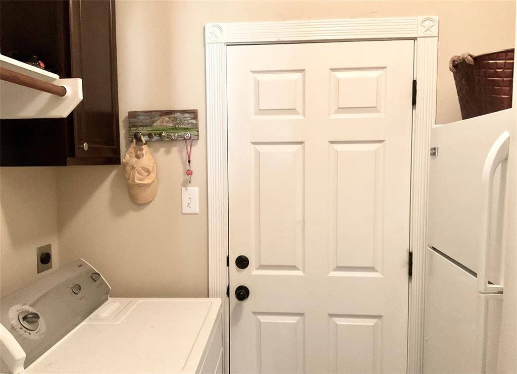 Your laundry room leading to the garage area and conveniently off the kitchen.   A washer, dryer and second refrigerator are provided for your use during your comfortable stay.
