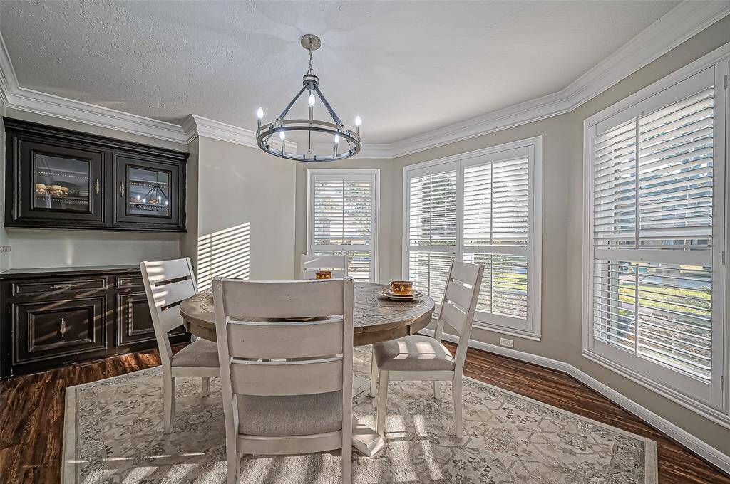 Elegant dining room with expansive, sunlit windows.