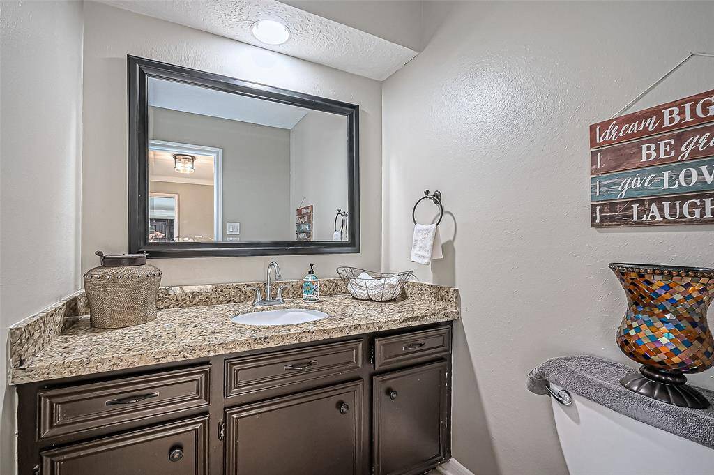 Convenient downstairs half bath with granite countertop.