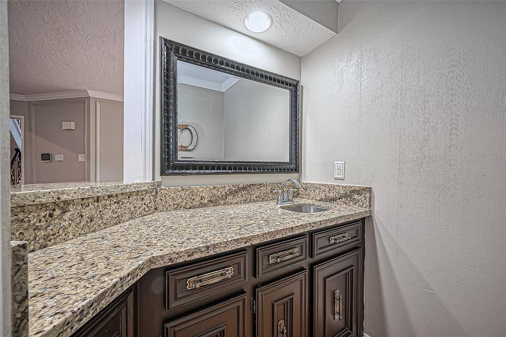 Chic wet bar adjacent to the living room, perfect for entertaining.