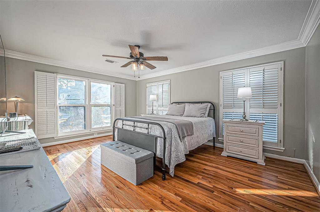 Luxurious primary suite with stunning shuttered windows.