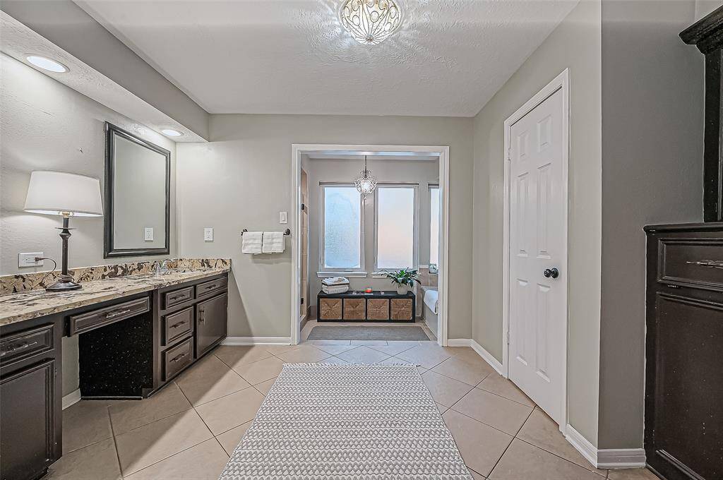 Luxurious primary bathroom featuring a spacious walk-in shower and a separate soaking tub.