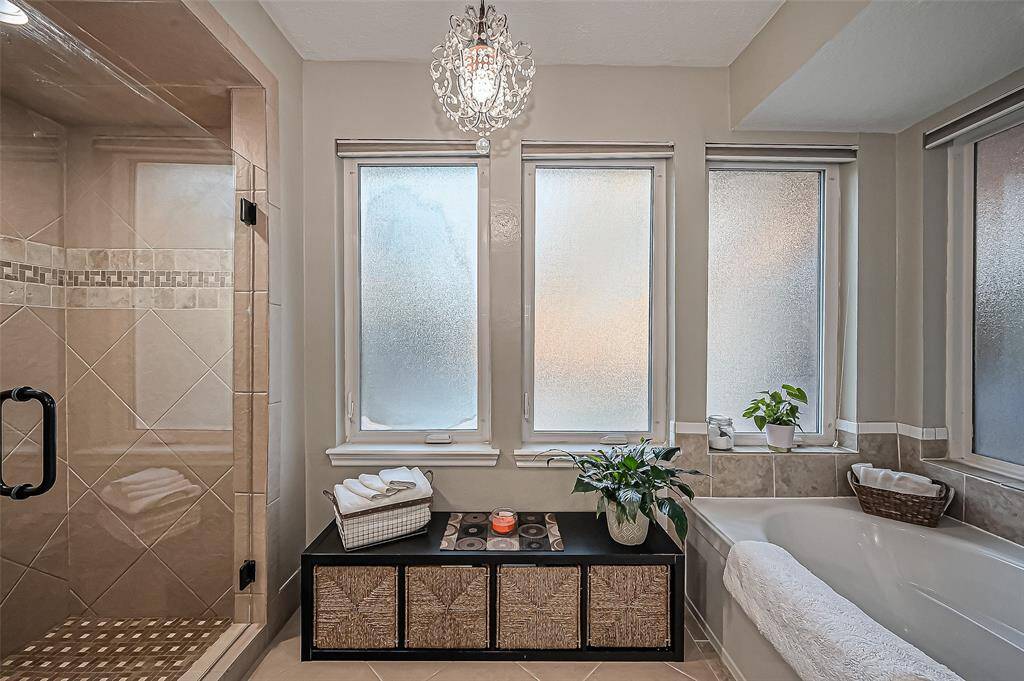 Indulge in your own spa-like oasis, highlighted by a stunning chandelier.