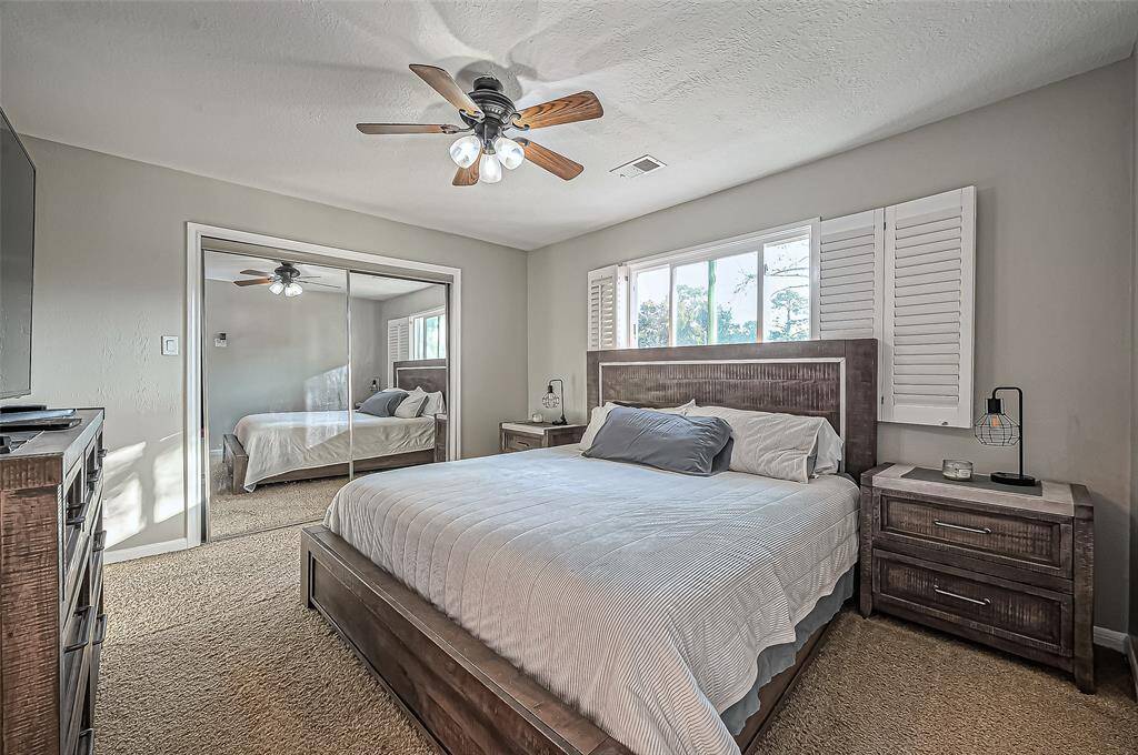 Secondary bedroom with mirrored closet.