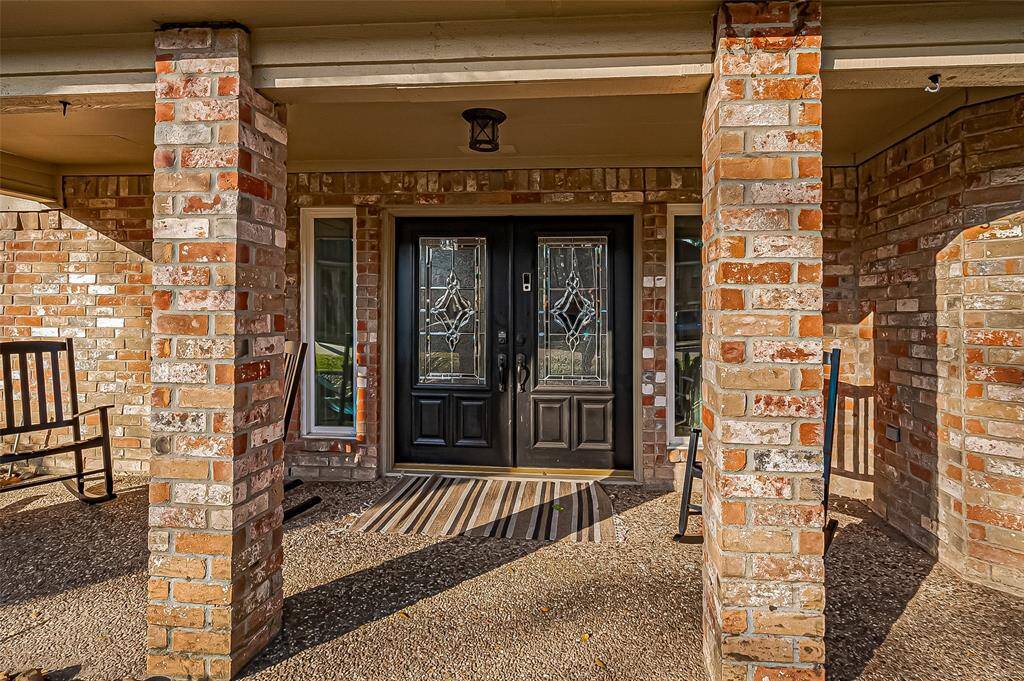 Welcome home to elegant double glass doors and a serene covered porch.