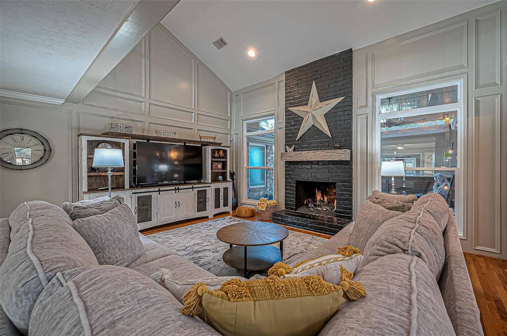Spacious living room featuring a stylishly updated fireplace.