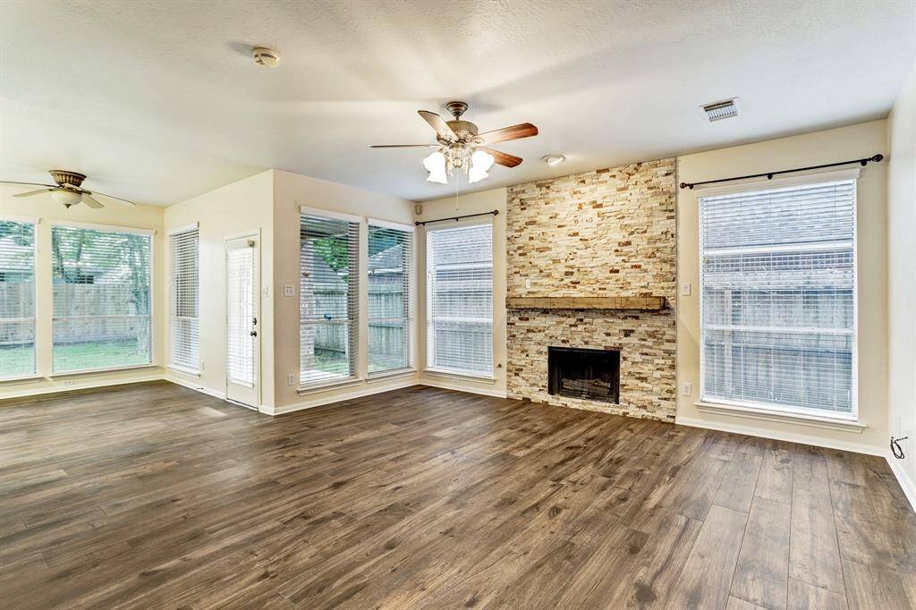 Perfect sized den with stacked stone fireplace surround