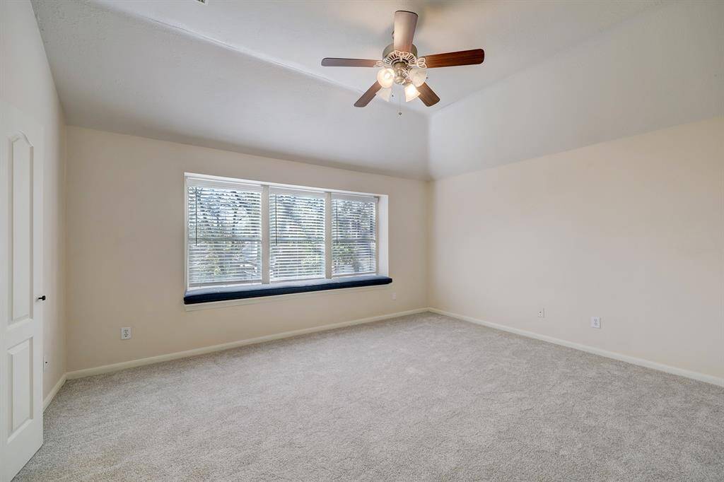 Primary bedroom has fresh carpet and lots of natural light