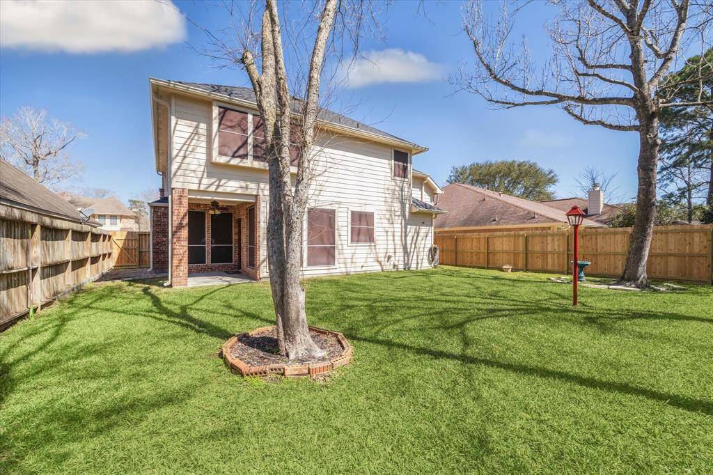 Large backyard with sprinkler system and plenty of room for the kids to play