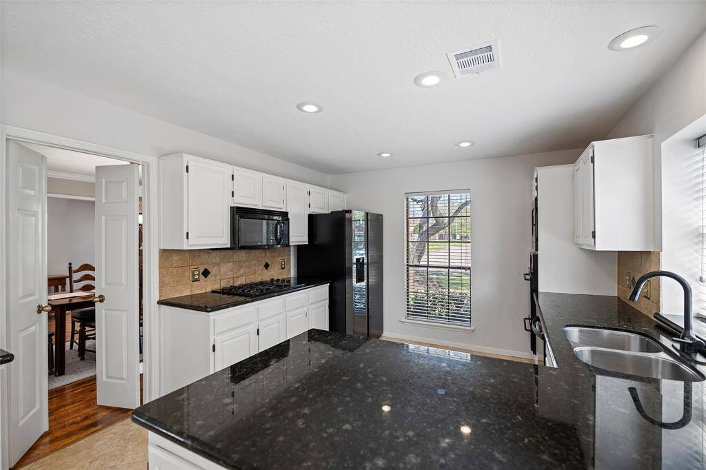 A freshly update to the kitchen beams with pride!  Crisp white cabinets adorned with gorgeous granite countertops offers plenty of prep and storage space!