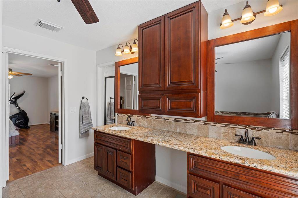 This primary ensuite has lots of storage with these custom cabinets with drawers!