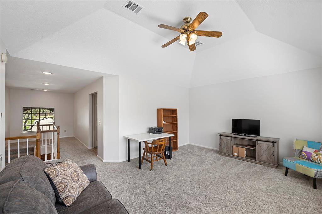 A large game room with vaulted ceilings is light and bright and ready for play action!