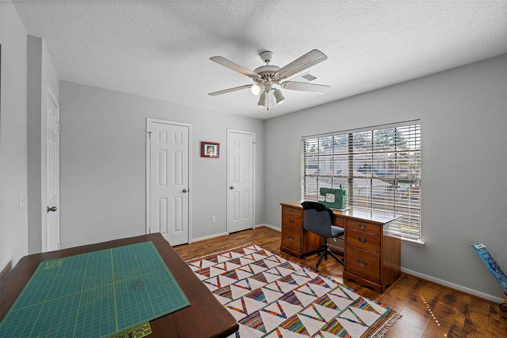 This home boasts 3 secondary bedrooms upstairs!  This room with a view is currently being used as a sewing room!  The beautiful flooring is the same as the downstairs creating cohesive look!