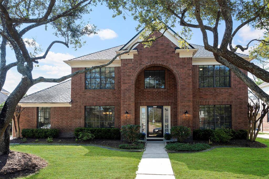 A stately exterior is complimented by mature trees and flowerbeds offering great curb appeal!