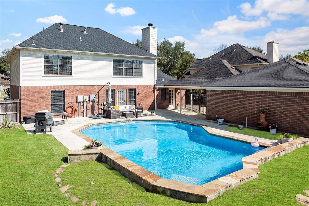 A raised wall with sheer double rain arches that add to the ambiance of this pool that was recently replastered and had the pool pump replaced with a multi-speed in 2024!