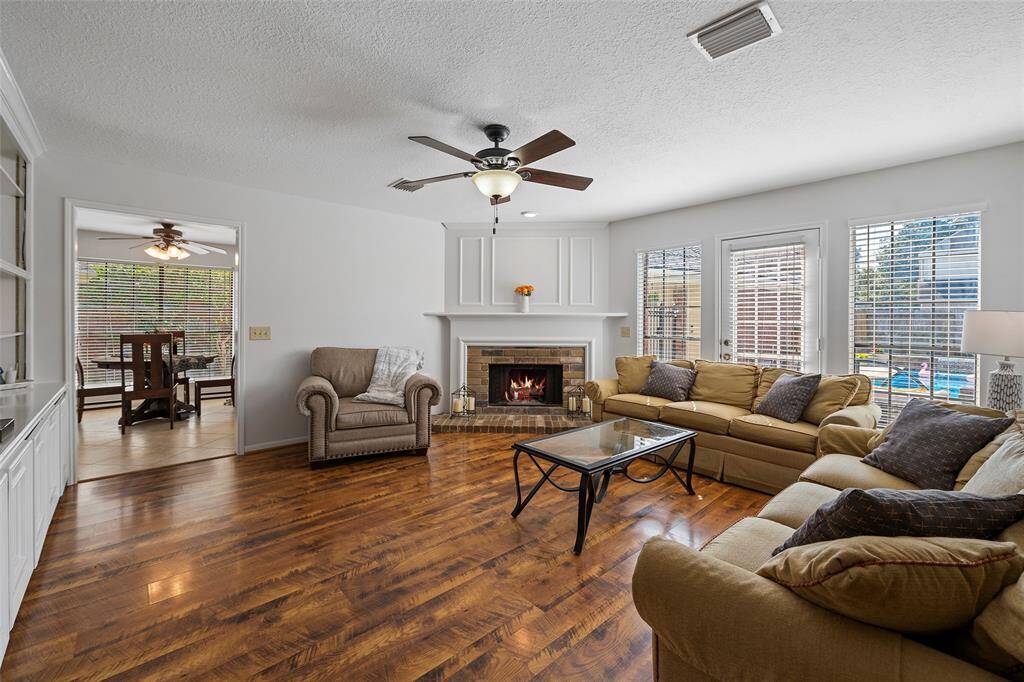 A cozy family room will surely be the HUB of the home, whether it is visiting with guests, or relaxing watching the big game!  The corner fireplace with mantel and wood wall detailing is a charming feature that will surely warm the hearts of all that gather here!