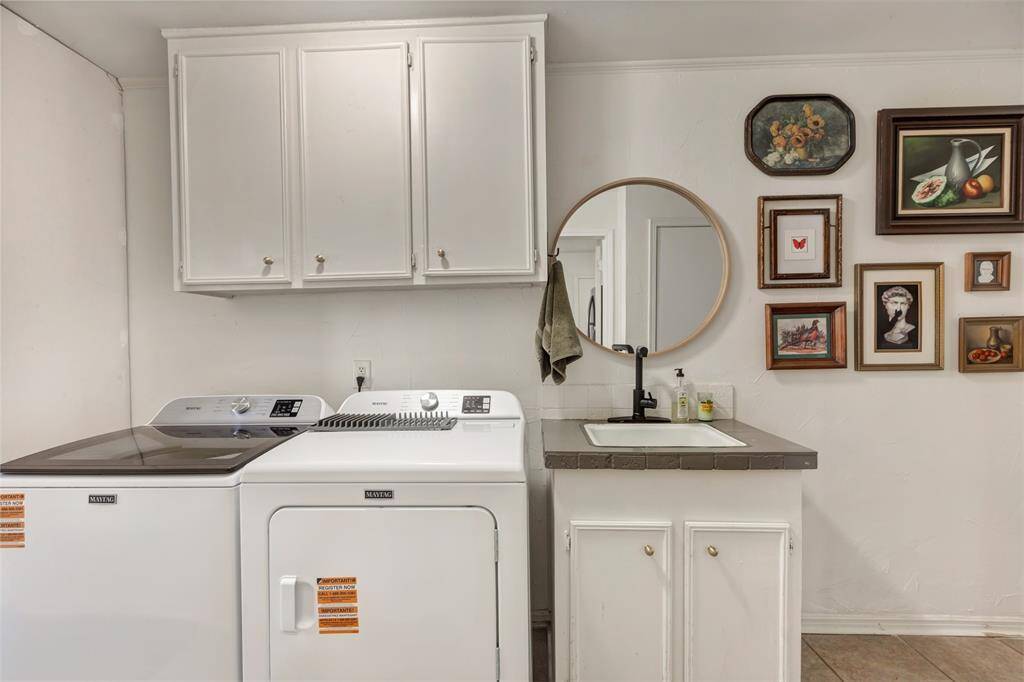 Large laundry room with sink & adjacent storage area