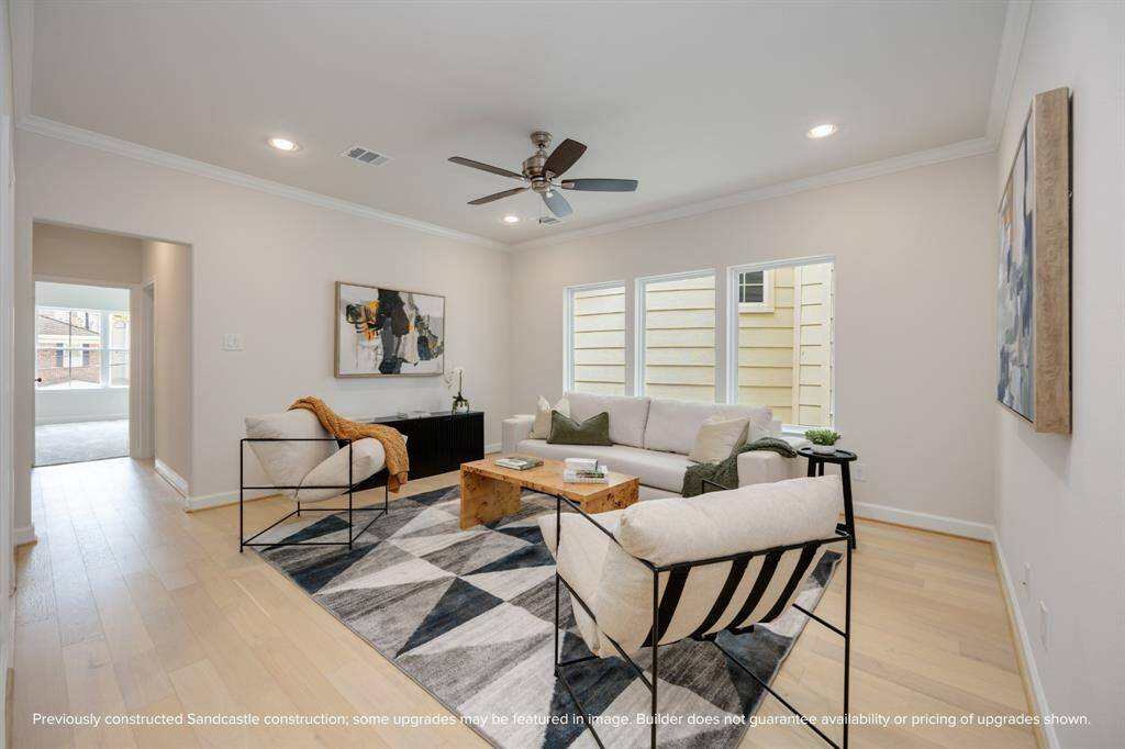 The second-story game room, a realm of leisure nestled between the serenity of the primary suite and the charm of a secondary bedroom, brightened by an expansive wall of windows.