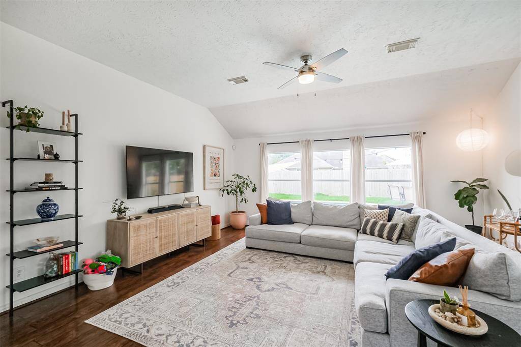 Beautiful floors, 3 large windows overlooking that backyard pool, and ceiling fan.
