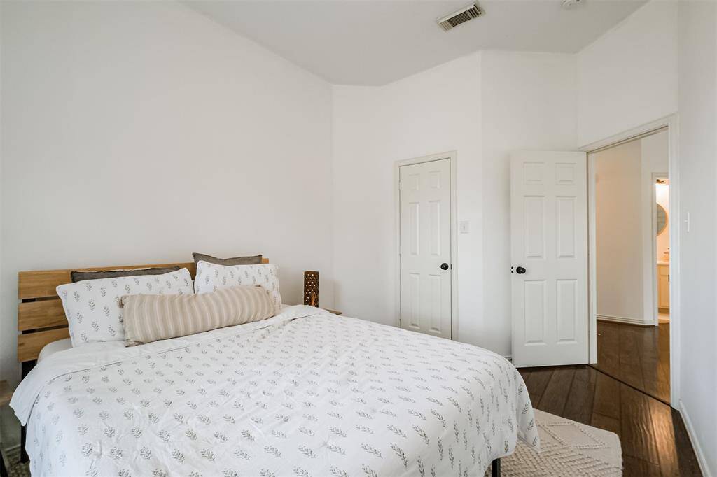 Another view of Bedroom number 3 showing off the high ceiling and updated floors.