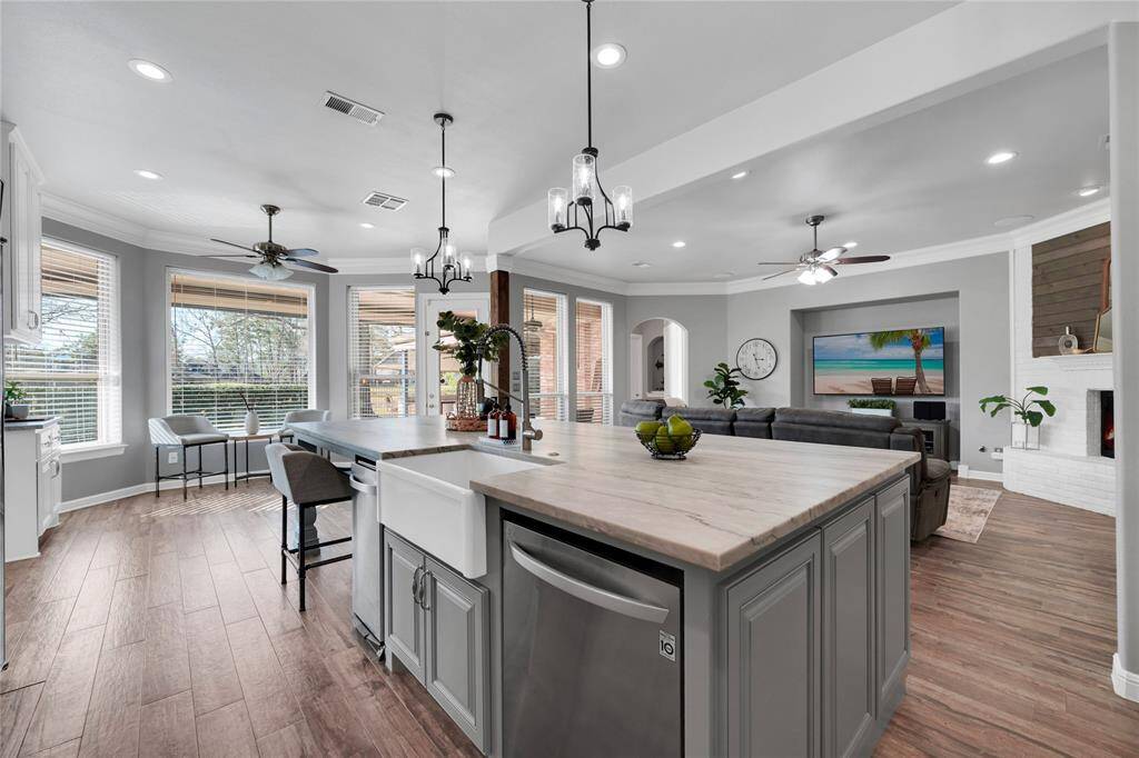Kitchen is truly the showcase part of the home. The huge leathered quartzite island is one piece, there are no seams. Seller spent over 8K on the island alone. Pendant lighting, cedar beam and floor-to-ceiling cabinets add a nice touch.