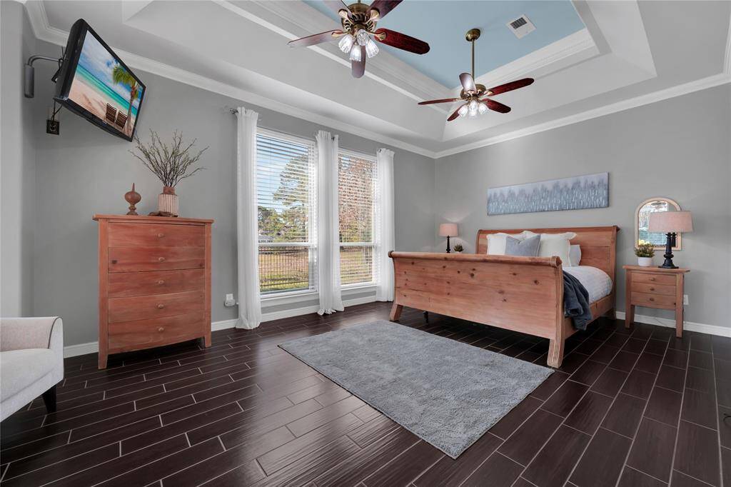 Master suite has a coffered ceiling and views of the swimming pool and golf course.