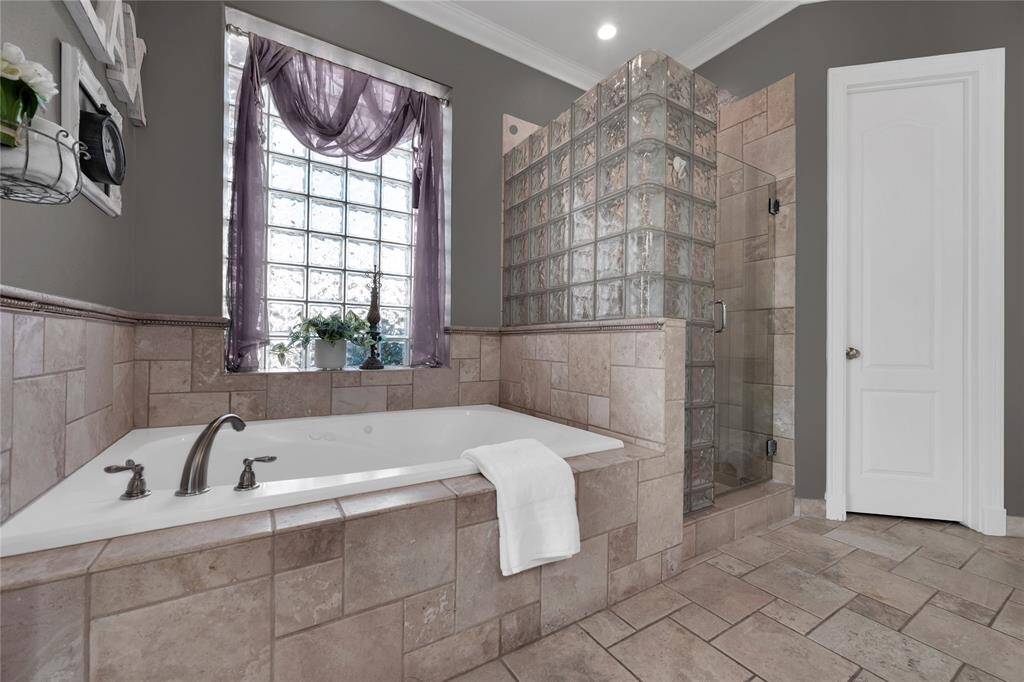 Master shower offers and additional handheld showerhead. Large closet offers additional built-ins.