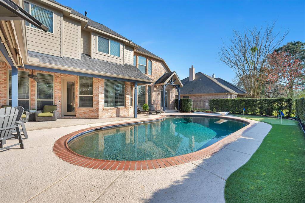 Installed AstroTurf and putting green is great for the avid golfer. Note, there is natural grass behind the outdoor kitchen for your fur babies.