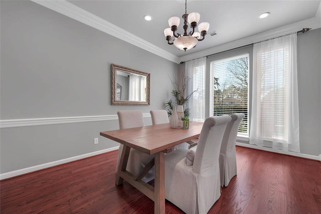 Formal dining has panoramic views of the golf course. The medallion and updated light fixture is a must see!