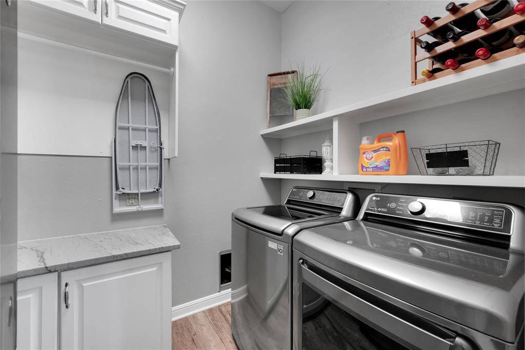 Utility room has quartz counters, and extensive built-ins. Barn door is stylish and very functional.