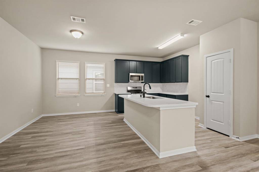 Island kitchen overlooking dining area