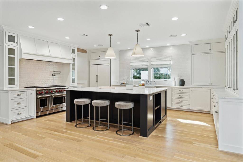 KItchen with custom cabinets, center island, marble countertops,.
