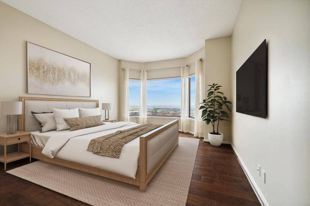 Lovely Primary Suite features hardwoods floors, amazing views, a sitting area/work space, en suite bathroom and a large walk-in closet. (Virtually staged)