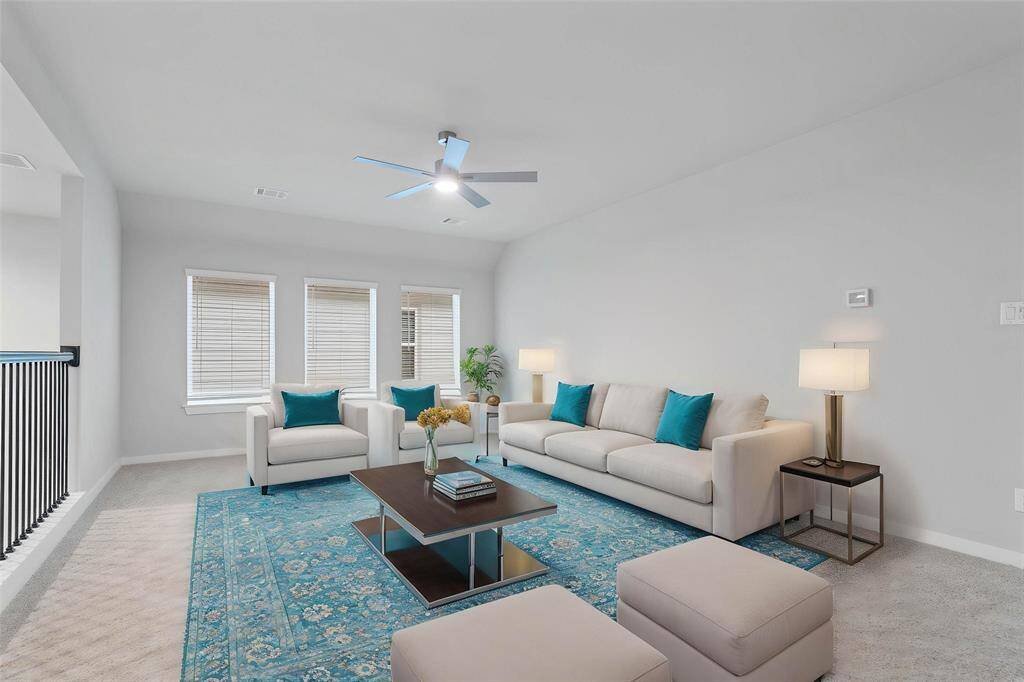 Come upstairs to this spacious and bright game room featuring custom paint with gorgeous plush carpet, ceiling fan, and large windows w/privacy blinds! With the ample amount of space provided, you can turn this area into anything!