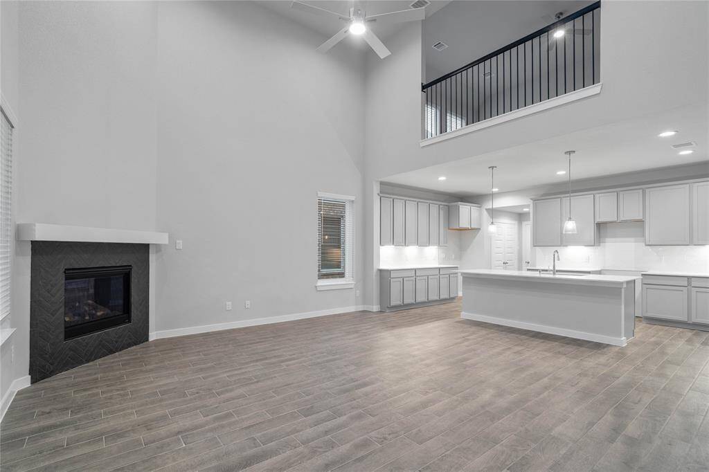 Additional view of this spacious family room looking into the kitchen and second floor game room.