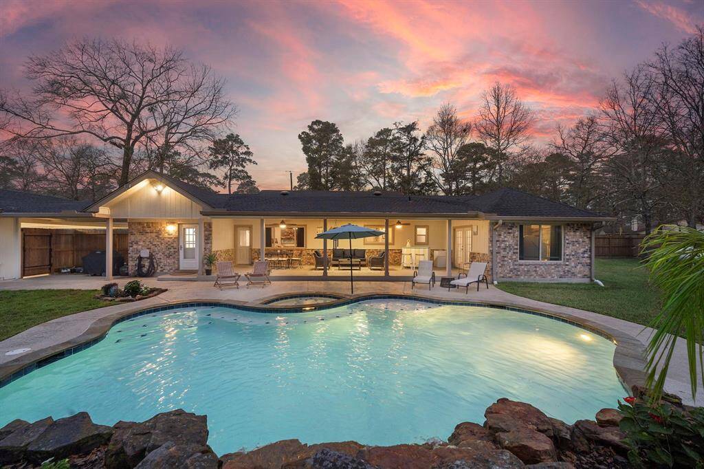 Beyond the patio, the resort-style pool and spa create the perfect setting for unwinding after a long day. The rock waterfall feature enhances the tranquil atmosphere, while the pool’s built-in seating and gentle curves add to its inviting appeal.