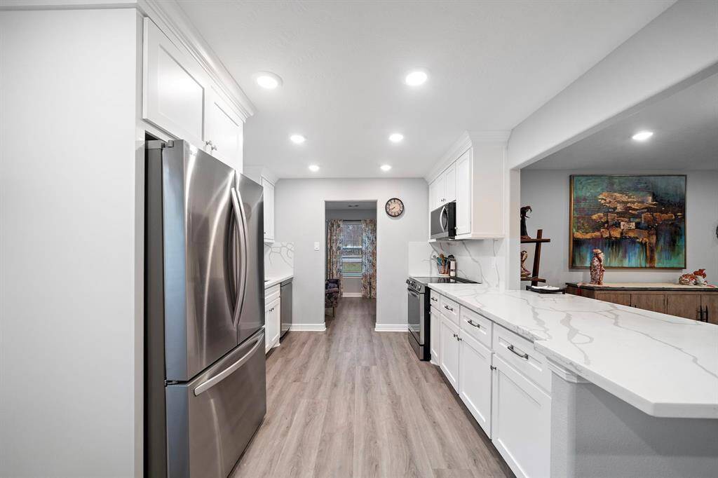 Kitchen opens to the dining space for effortless hosting.