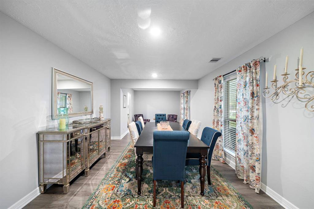 The open-concept design seamlessly connects the dining area to the rest of the home while maintaining a sense of elegance and distinction. Recessed lighting ensures a bright yet cozy ambiance.