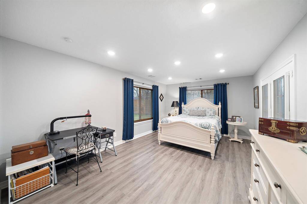 A generously sized primary bedroom with abundant natural light and a private entrance to the backyard.