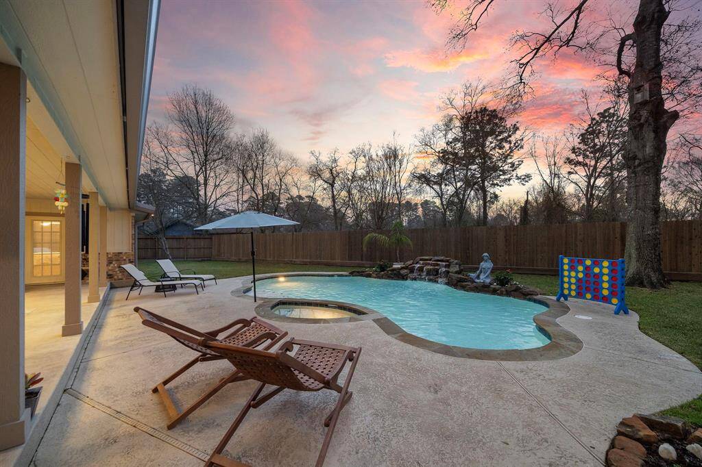 The resort-inspired backyard is designed to maximize relaxation and entertainment, with a stunning pool, shaded patio, and lush landscaping.