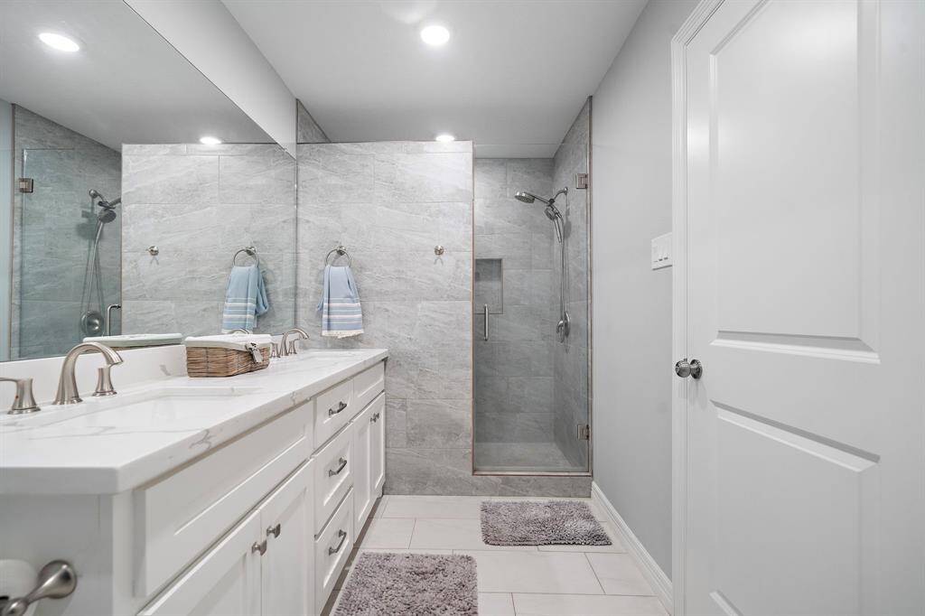 A stylish vanity with marble countertops and dual sinks provides functionality and elegance.