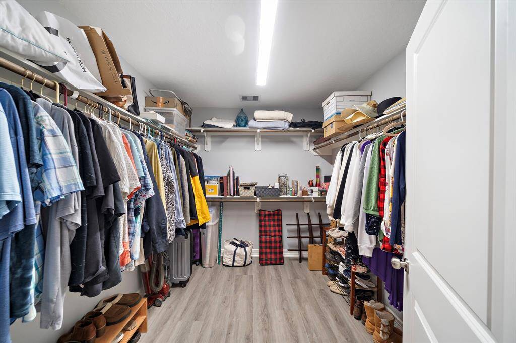 Plenty of storage in the walk-in closet with built-in shelving and hanging space.