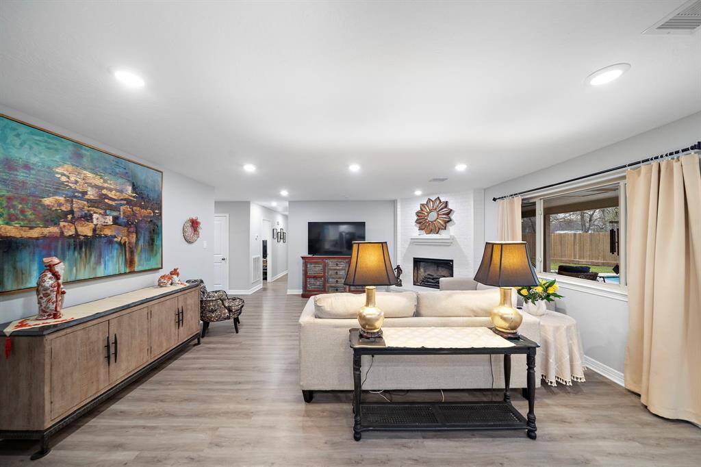 This open-concept design offers versatility and functionality, perfect for entertaining or everyday living. The neutral color palette and updated lighting create a welcoming ambiance, ready to complement any style.