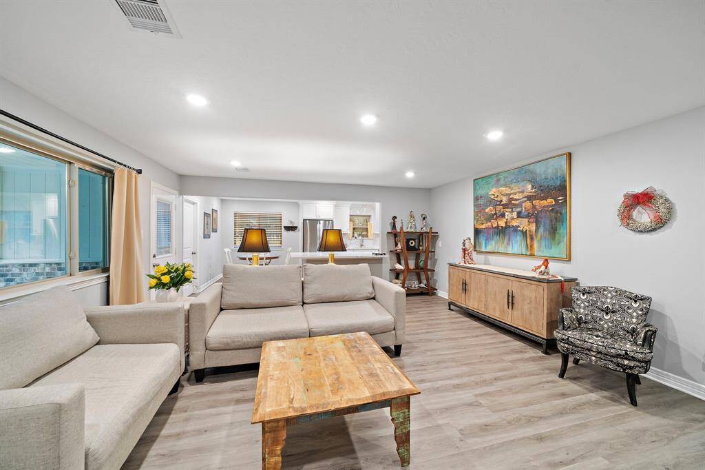 Designed with an open floor plan, this inviting living space seamlessly connects to the kitchen and dining areas.