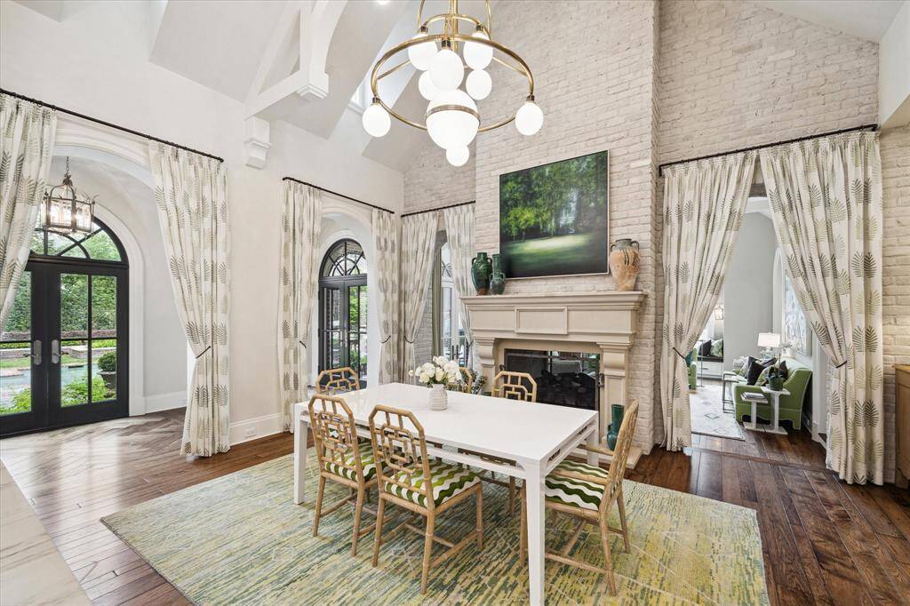 The breakfast room seamlessly connects to the kitchen. Here you will find exposed brick walls that have been slurried by Segreto. A dual fireplace is shared with the sunroom. Here is another gathering space perfect for kids doing homework and cozy dinners in.