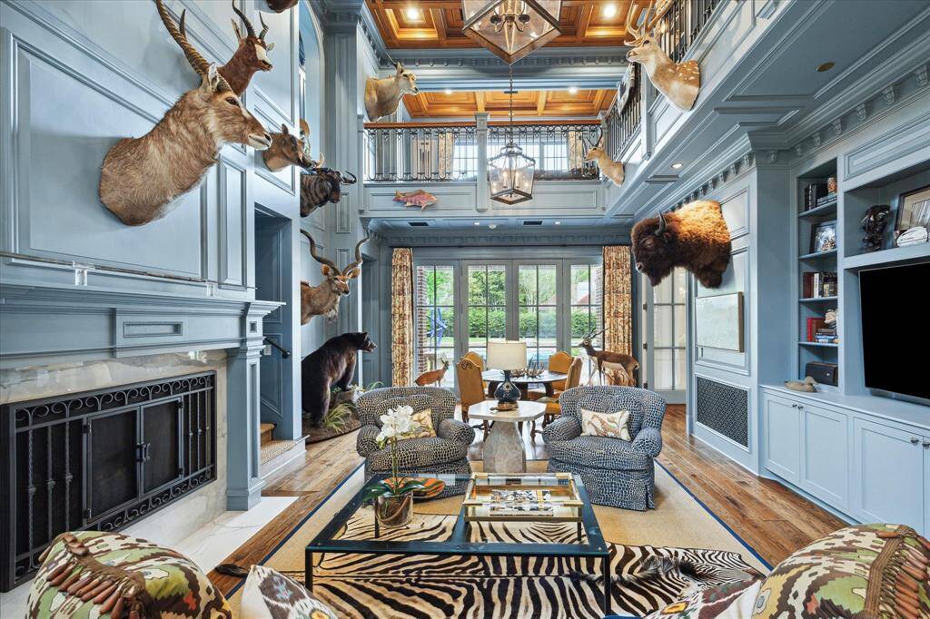 Another room that has beautiful views of the pool and grounds is the handsome two story study and library with its intricate ceiling and moldings. Room features richly painted cypress walls and cabinets and a marble surround fireplace. This showstopping room has great display walls, built ins and lighting to feature precious collections.