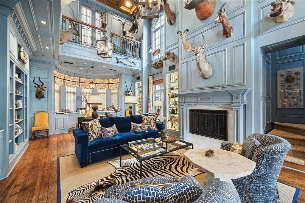 Here's a different angle of the library/study that highlights the incredibly quality of construction that is apparent throughout the home. Notice the ornate millwork, the second story balcony, the rounded window creating a natural workspace and the multiple windows flooding the room with natural light. Don’t miss the hidden stairway that leads up to the second story and into the primary retreat.