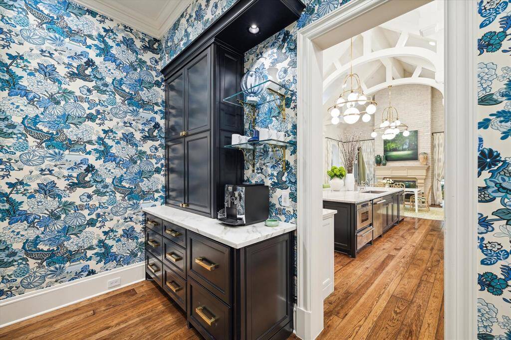 Here’s the coffee bar with two refrigerator drawers and ample storage. It is part of the mud room off of kitchen that also leads to the oversized pantry and two garages. One garage holds three cars and the other is an air conditioned single garage that is perfect for your prized sports car or for a workshop.