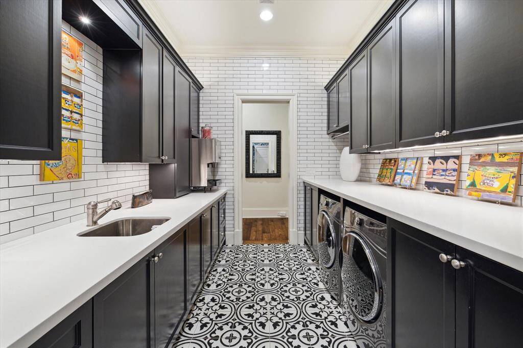 Downstairs laundry room where you can do your laundry in style! There’s also an upstairs laundry room that serves the primary and secondary bedrooms.
