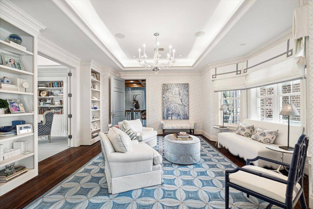 The primary suite occupies its own wing of the house for ultimate privacy. This light and bright morning room can also be accessed by the second story library/study and has its own private porch with views of the extensive backyard grounds and pool.